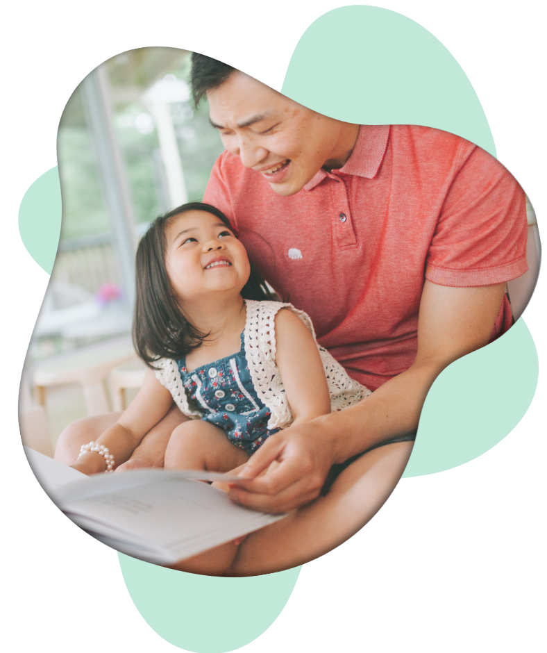 Dad with little girl reading a book