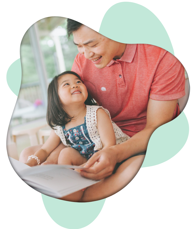 Dad with little girl reading a book