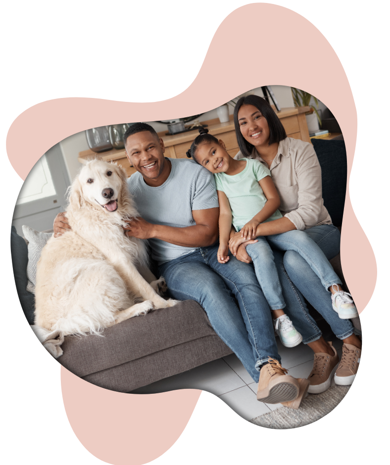 family with young child and dog on a couch