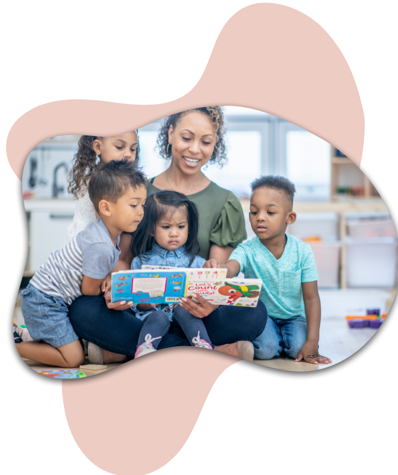 Daycare professional with 3 kids reading a book